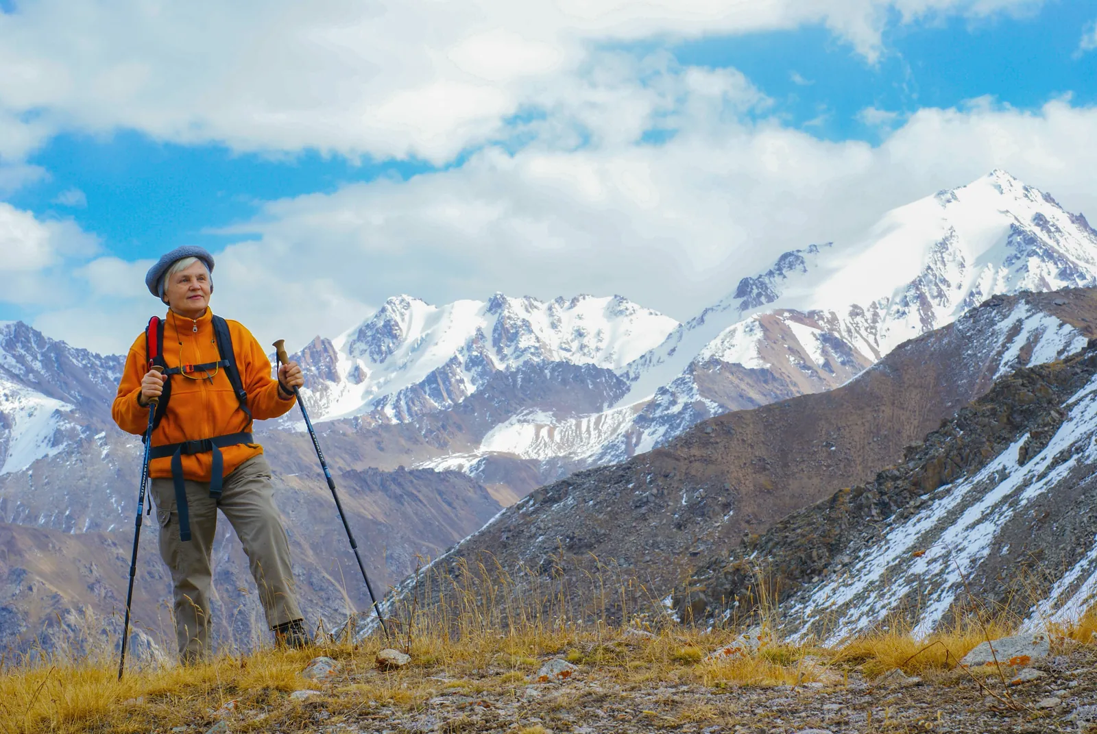 An older woman hiking in the mountains.