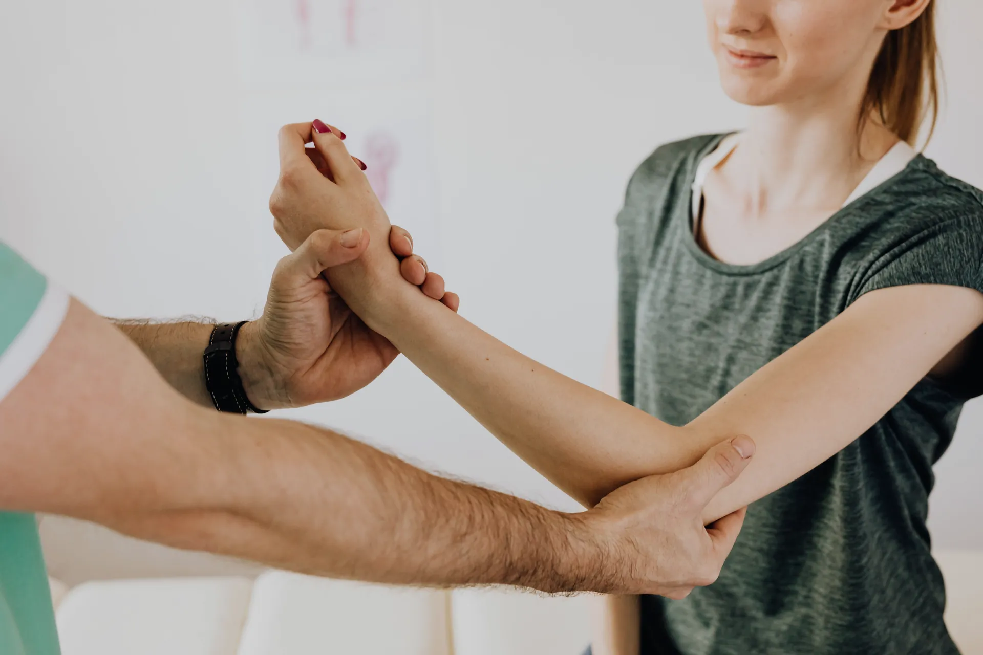 A physiotherapist working on a patient’s arm.